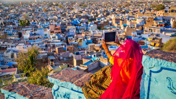 istock Young Indian woman taking a picture using digital tablet, Jodhpur, India 1429273689