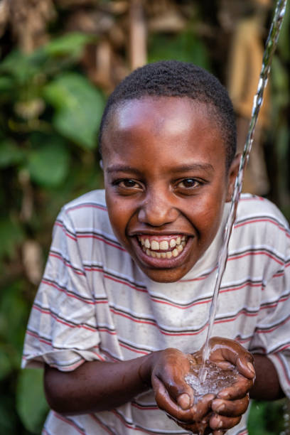 istock African young boy drinking fresh water, East Africa 1429273721