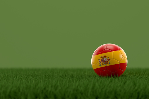 3d rendering of soccer ball with Spain flag on a grass field.