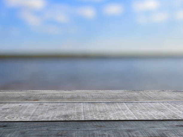 istock Old wooden table shelf, turquoise lake blur background. 1429278854