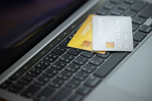 Credit cards on the laptop keyboard. Open access for online shopping, Credit card close up shot with selective focus, Concept of Online shopping and payment.
