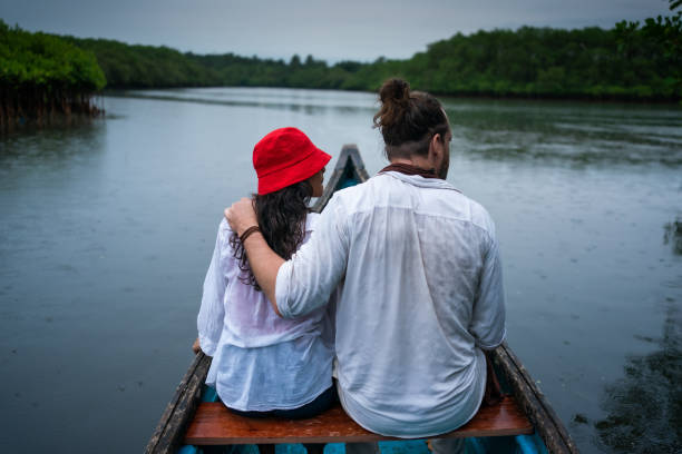 istock Couple bird watching on a river boat 1429285647