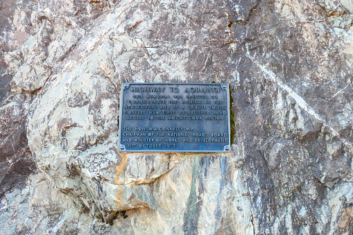 Plaque attached to a large rock placed next to Mount Cook Road in the Aoraki Mount Cook National Park.  The plaque is dated 31 October 1975 and commemorates the opening of the road and the pioneers who opened road access to the region.  \