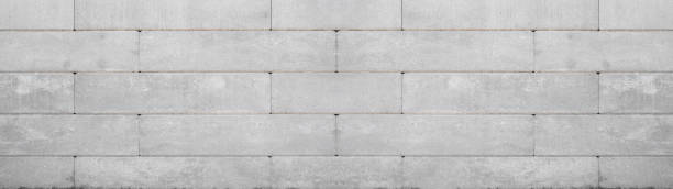 istock Gray retaining wall garden from concrete shuttering blocks masonry brickwork wall texture banner panorama 1429290678