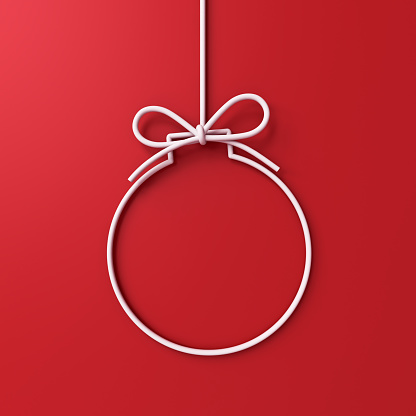 Hanging white christmas ball or bauble frame border isolated on red background with shadow minimal conceptual 3D rendering