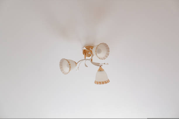 istock classic ceiling lamp with white lampshades with gold decor. 1429294852