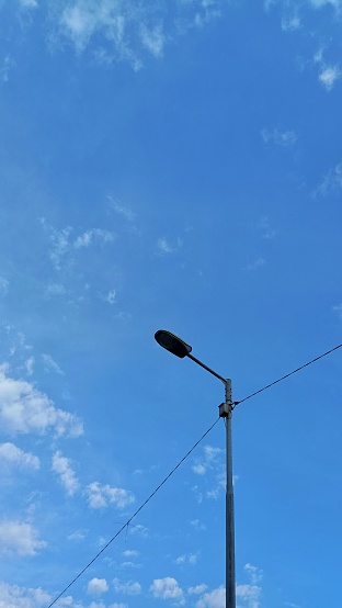 Street lamp post with lights on.