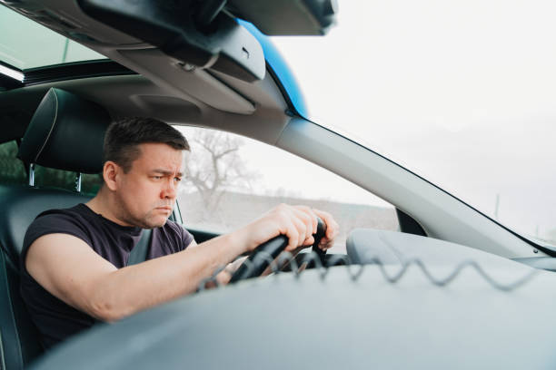 istock a serious and angry man drives a car on the highway 1429298848