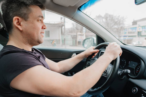 istock a cheery man drives a car on the highway 1429298906