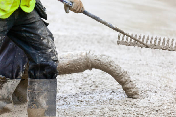 istock Pouring and Raking a Concrete Foundation Slab 1429304076