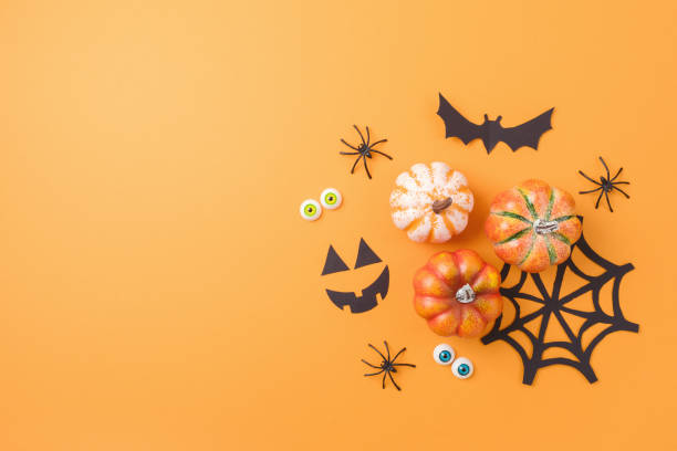 istock Halloween concept with pumpkin and decorations on orange background. Top view, flat lay 1429305470