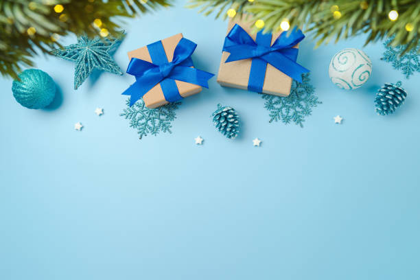 istock Christmas tree with gift boxes and decorations over blue background. Top view, flat lay 1429305535