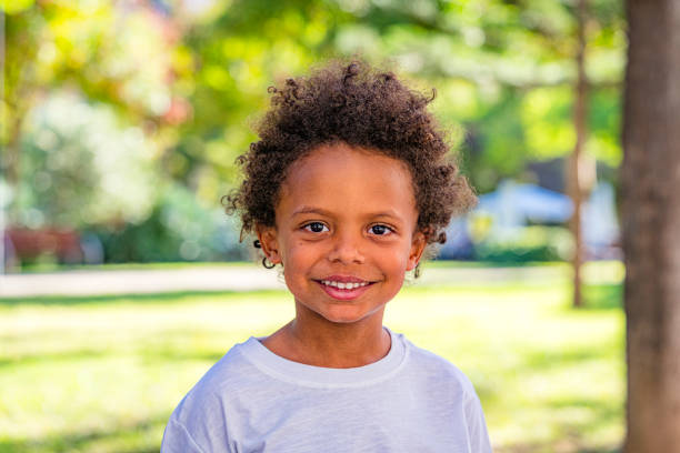 istock Smiling five years old boy portrait outdoors 1429305582