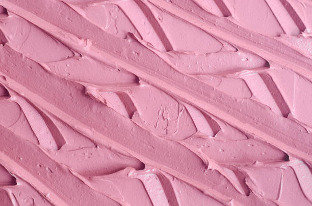 istock Pale pink cosmetic clay (alginate facial mask, face cream, body wrap) texture close up, selective focus. Abstract rose background with brush strokes. 1429312855