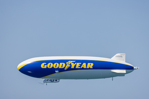 Bodensee, Germany - July 22, 2022: Side view of the Goodyear Blimp zeppelin flying over the Bodensee in Germany and Austria