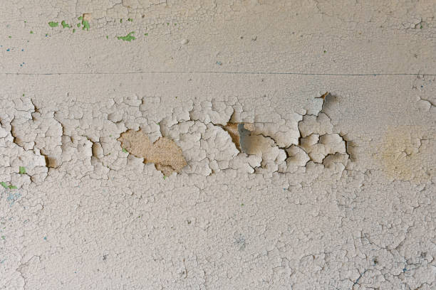 Background of the old wall in the abandoned apartment. Old paint cracked stock photo