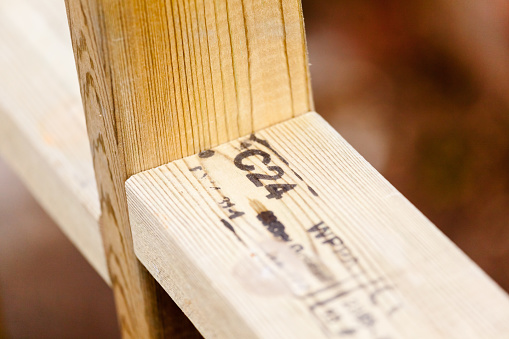 [Inspector, the identifiable marks on timber are generic Building Standards references to determine the quality and grade. They DO NOT relate to any trade marks or companies or brands: C24 is the highest Grade of Construction Timber, WPPA (right) is the Species Group of Trees, The partially legible numbers (lower left) are Standard Reference Numbers. Thanks].\n\nKiln Dried, Timber Frame Stud Wall construction using the highest European structural grade, C24, for integrity, strength and lower knot-count. WPPA is the reference to the species group of trees. This timber is also pressure treated with a preservative for durability and longevity. The treatment is a combination of copper and biocides. In summary, slower-grown C24 lumber is the best structural timber widely available timber for it's quality, integrity, strength and longevity. The universal grading is used across the UK and Europe