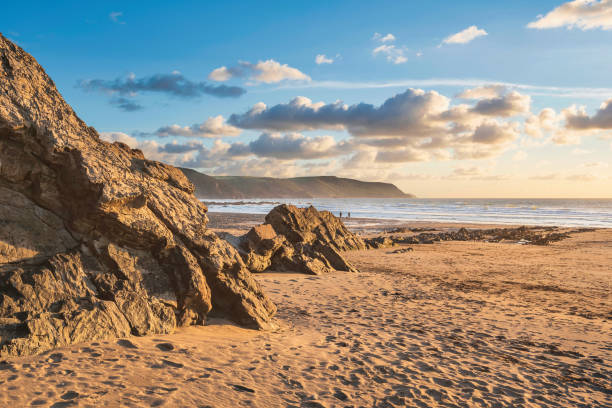 Stunning Summer sunset landscape image of Widemouth Bay in Devon England with golden hour light on beach stock photo