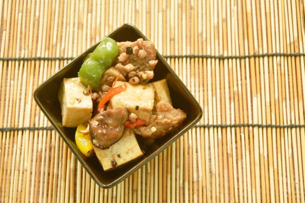 fried tofu with bell pepper in black soy sauce on cup