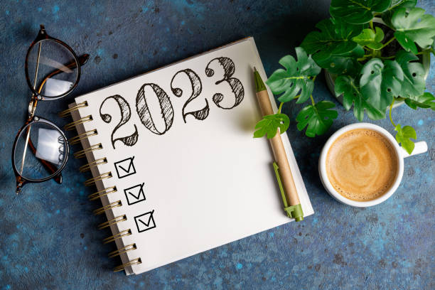istock New year resolutions 2023 on desk. 2023 resolutions list with notebook, coffee cup on table. Goals, resolutions, plan, action, checklist concept. New Year 2023 template 1429333664