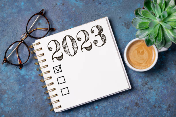 istock New year resolutions 2023 on desk. 2023 resolutions list with notebook, coffee cup on table. Goals, resolutions, plan, action, checklist concept. New Year 2023 template 1429333692