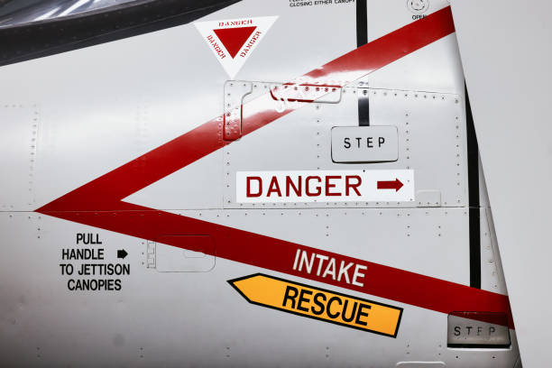 Danger aircraft jet ejector seat rescue and intake signs Danger aircraft jet ejector seat rescue and intake signs on side of modern military airforce plane. jet intake stock pictures, royalty-free photos & images