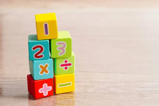 Photo of Number wood block cubes for learning Mathematic, education math concept.