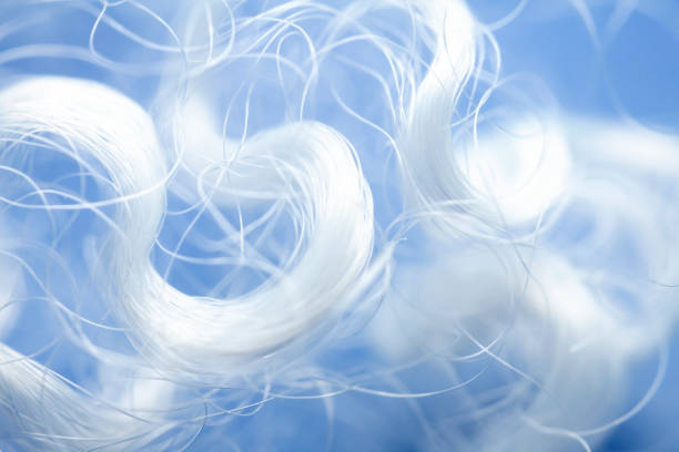 Extreme macro of polyester stable fiber on blue background Extreme macro of polyester stable fiber on blue background. Selective focus, shallow depth of field. Abstract dreamy background polyester stock pictures, royalty-free photos & images