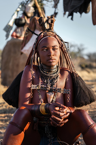 Young Himba woman dressed in traditional style in Namibia, Africa.