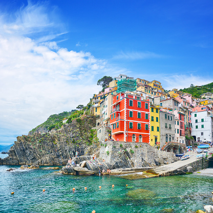 Riomaggiore is one of the five towns that make up the Cinque Terre region in Italy. Composite photo