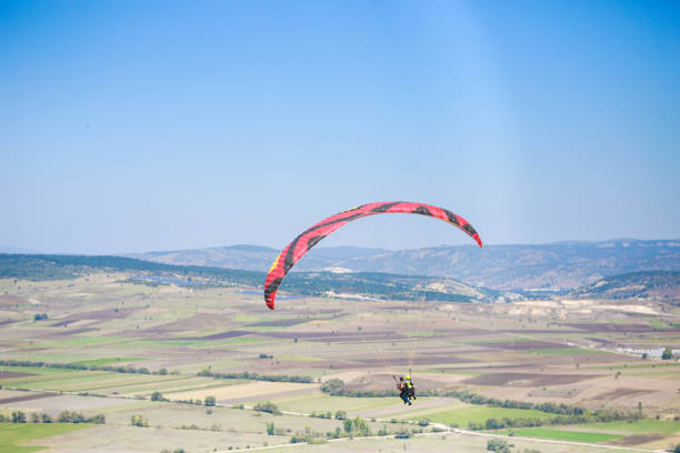 istock A man paragliding in the blue sky 1429347043