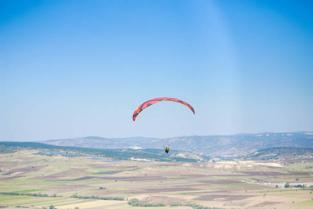 Hang glider for riding tourists in the field. Two-seater hang glider flying in the sky. High quality photo