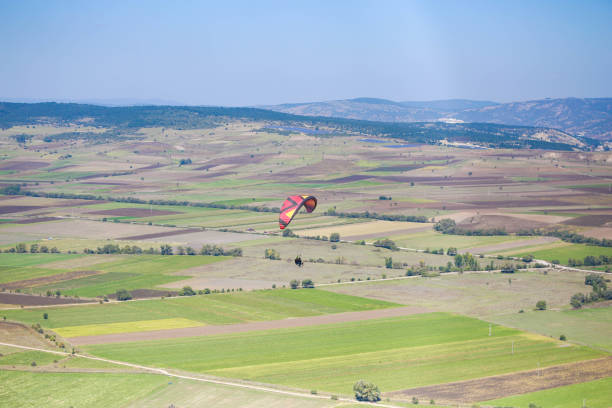 Young man flying with colorful paraglider. extreme sport