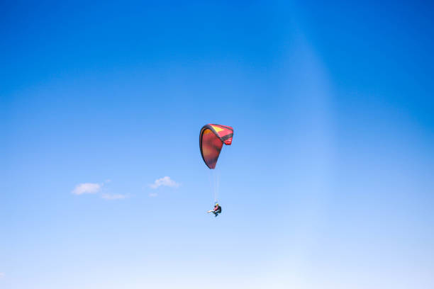 young man paragliding in clear cloudy weather