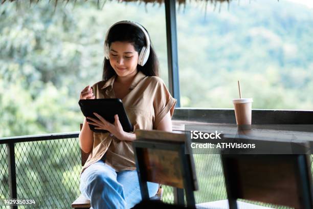 Woman Adult Student Studying Online Class With Virtual Tutor Reskill On Her Work At The Park Stock Photo - Download Image Now