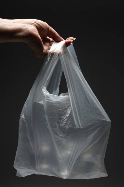 istock Man holding glasses in a plastic bag 1429355379