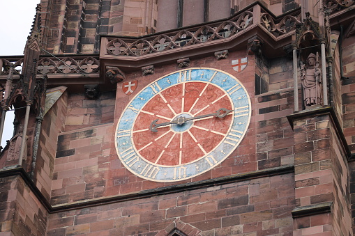 The clock on the tower of a church in Freiburg.