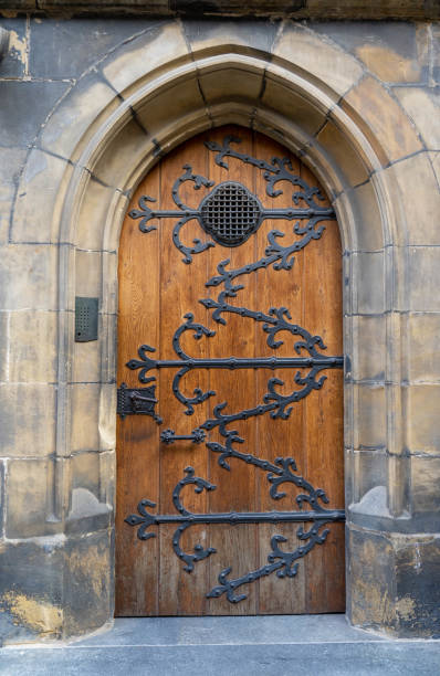 istock Old wooden Gothic door in stone cathedral 1429369327