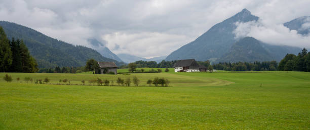 istock Farm houses in valley between mountains 1429369476