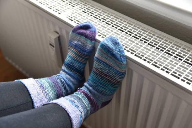 istock a woman with socks on a heating 1429371818