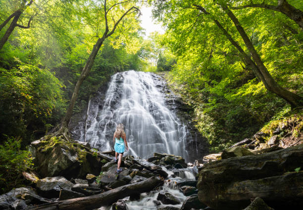 istock Woman enjoying beautiful waterfall. 1429372475