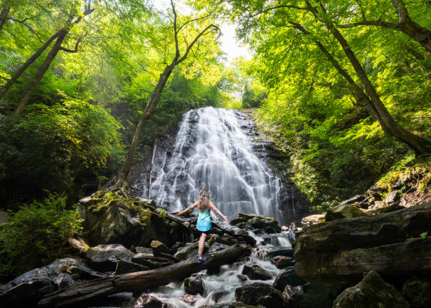 istock Girl with hands up relaxing in the forest. 1429372512