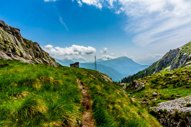 abandoned and semi-destroyed alpine hut among the grazing meadows and the granite mountain peaks of the Lagorai in Trento Italy
