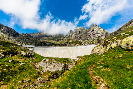 dam emptied by drought between the granite peaks of the Lagorai in Trento Italy
