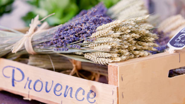 Wooden Box with the script text, Provence containing bunches of dried Provence Lavender and Dried Wheat stems tied in bunches, for sale at St Tropez market Cote D'azur