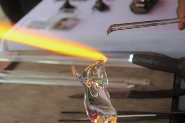 Glass melting hand made Glass melting hand made with hot burning and blowing fire header hand blown glass stock pictures, royalty-free photos & images