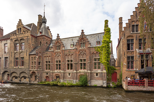 Burges, Belgium - 18 August 2018: View of the buildings along the Dijver canal in Bruges, the capital and largest city of the province of West Flanders.