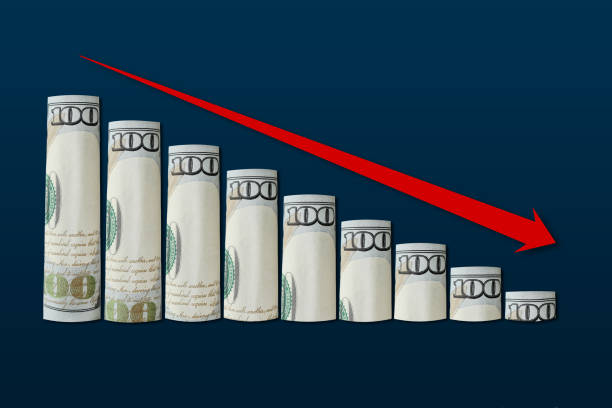 istock Rolled up dollar bills falling graph with red down arrow. Business concept, financial fall chart, analytics 1429378155