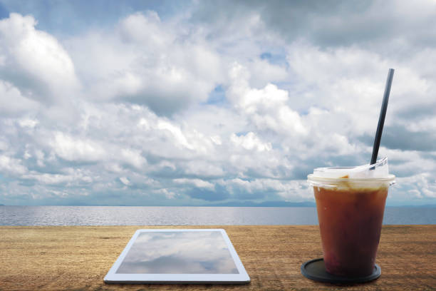 Young woman using digital tablet at cafe