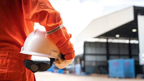A worker is holding white safety helmet - Safe working practice.